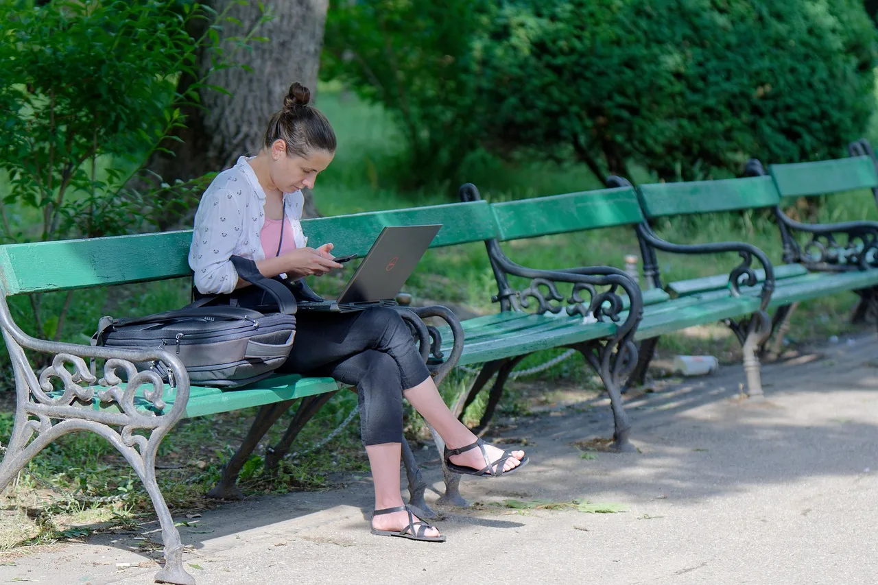 woman, laptop, bag, watching, smartphone, sitting, bench, parka, naturally